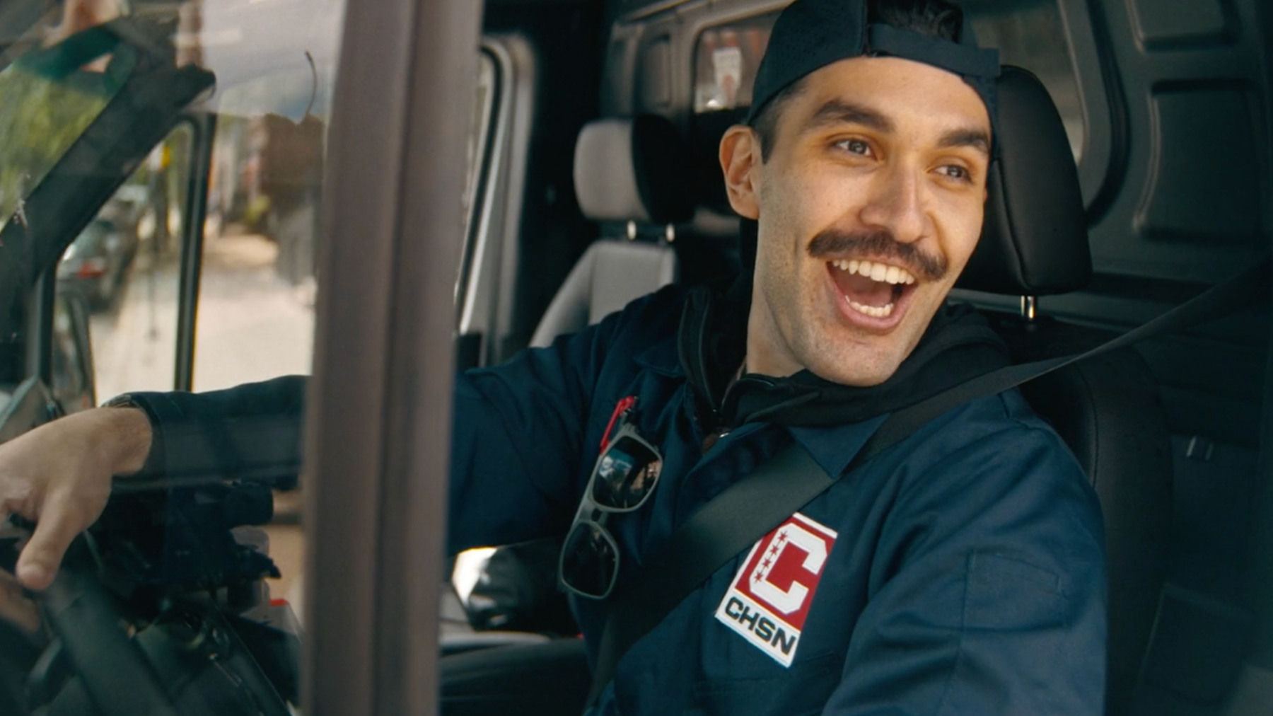 Chicago Sports Network delivery driver seated in a branded van