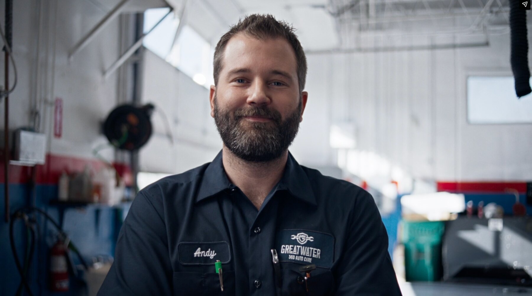 Greatwater technician Andy standing inside an auto repair shop