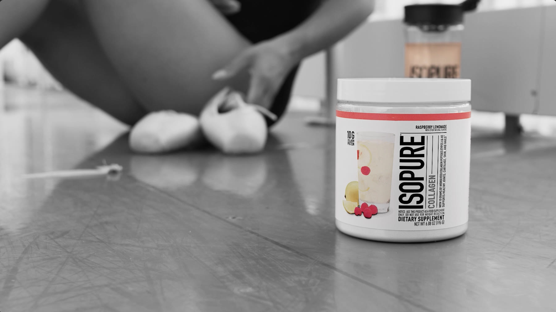 Isopure Collagen product on a counter in a black-and-white studio