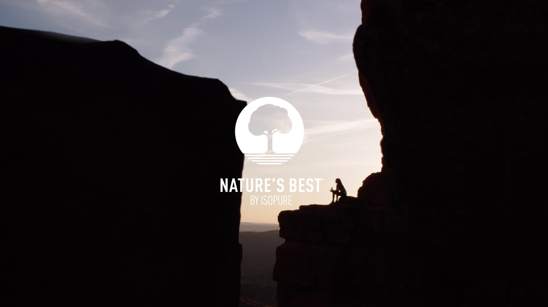 Nature's Best logo over a hiker silhouetted between red rock formations