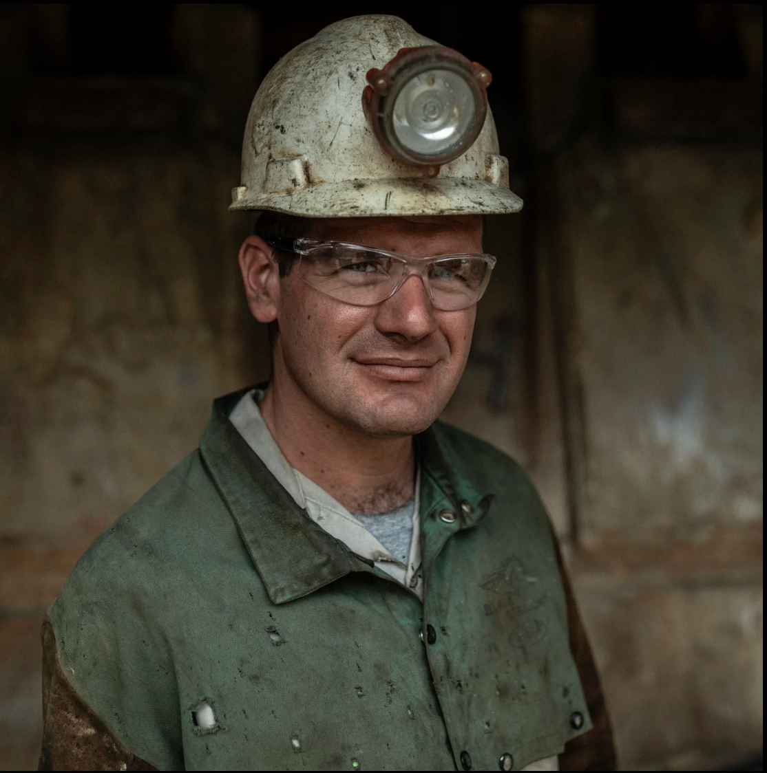 Miner wearing a hard hat and safety glasses