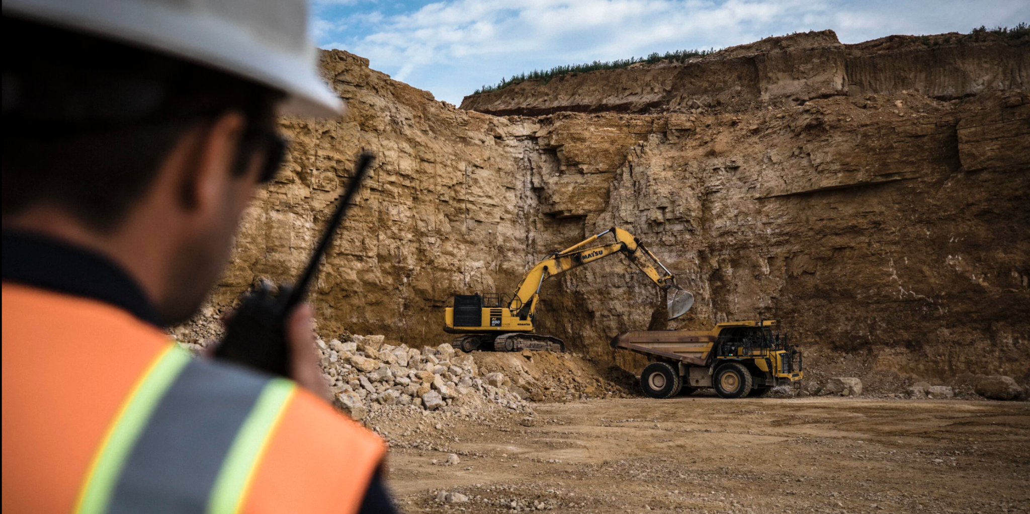 Quarry operator overlooking an excavator and haul truck